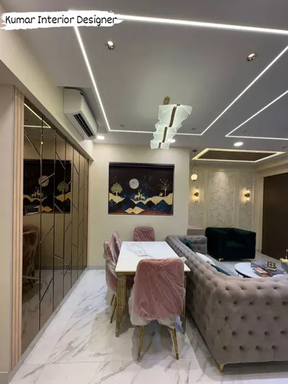 The dining area is defined by a mirrored wall and a statement chandelier, creating a bright and luxurious space for family meals.