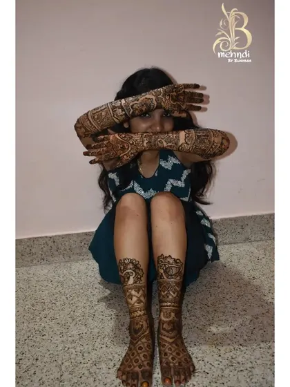 A duplicate of the client with matching hand and feet mehndi.