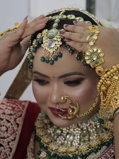 The bride adjusting her headpiece, giving a clear view of the detailed craftsmanship of her bridal accessories.