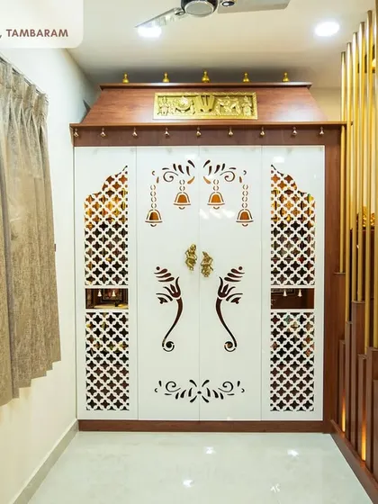 An ornate and traditional pooja unit from the Tambaram villa, with intricate CNC-cut doors, a classic wooden frame, and golden accents.