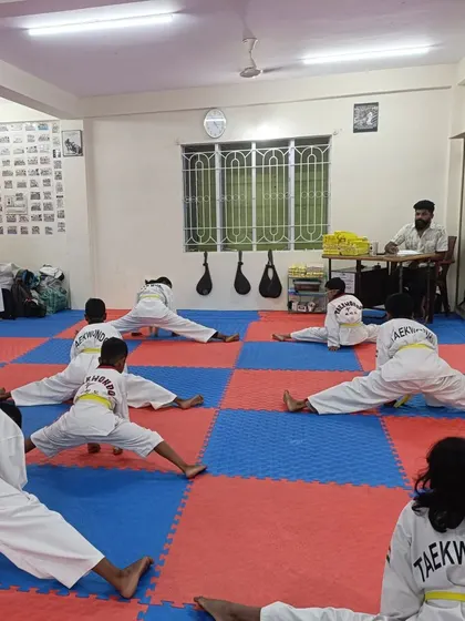 A group of yellow belts working hard on their flexibility.