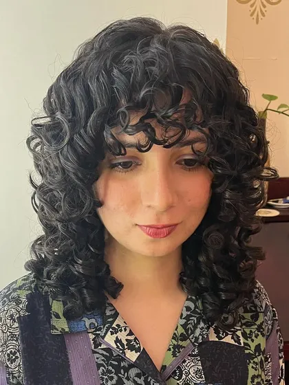 Surabhi's curly shag with bangs, a style that perfectly frames her face.