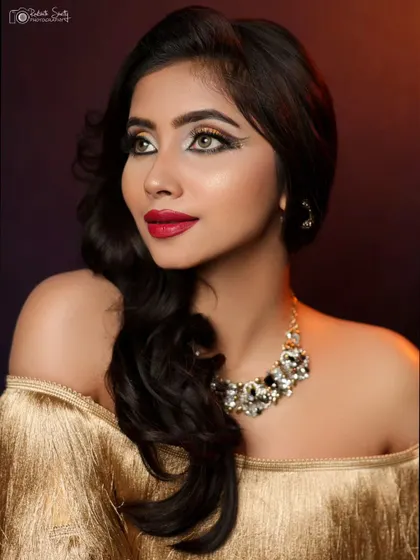 A close-up that highlights the winged eyeliner and bold red lip, perfect for a makeup artist's portfolio.