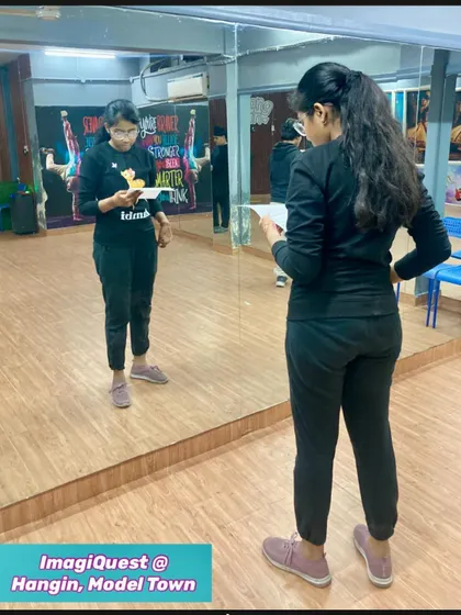 A student practices her monologue in front of the mirror for our "Shaking Shakespeare to Life" theatrical. This mirror work is a key technique we use to help actors refine their expressions and body language.