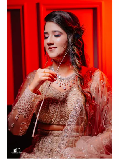 Using bold red lighting to create a striking and modern bridal portrait. This shot highlights the bride's elegant profile and the delicate details of her jewelry and hairstyle.