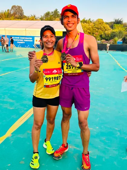 Posing with a fellow runner after the TCS10K. The camaraderie and shared experience of race day is a huge part of what makes the running community so special.