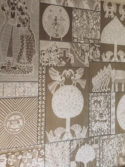 A full view of a custom wallpaper inspired by traditional Indian folk art, possibly Warli or a similar style. The monochrome design creates a very earthy and artistic statement wall.