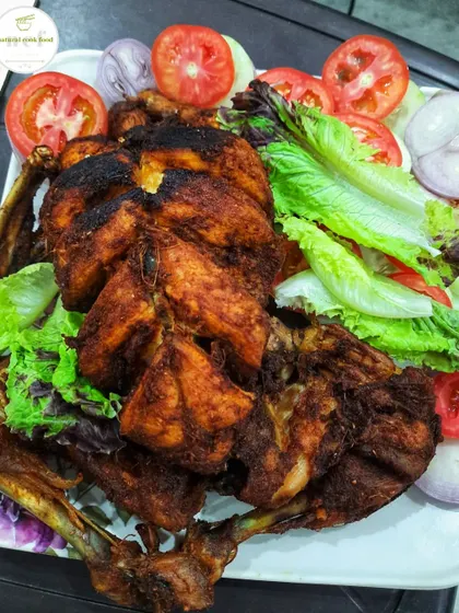 A full chicken roast, beautifully browned and served with a fresh salad.