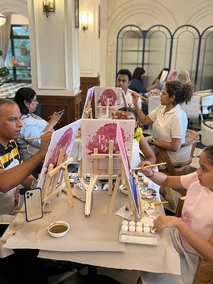 A family enjoying the painting process at our Kochi event. Our workshops are a great activity for all ages to enjoy together.