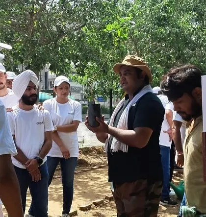 Our expert briefs the Orbis Financial team at Aravali Creek, explaining why native saplings are crucial for boosting local ecosystems and conserving water.