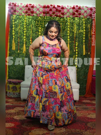The bride twirling in her colorful Mehndi lehenga. The vibrant patchwork design and mirror work make it a truly joyful outfit.