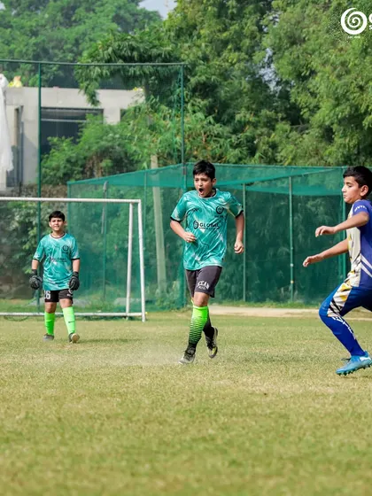 A player runs onto a through ball, aiming for a shot on goal.