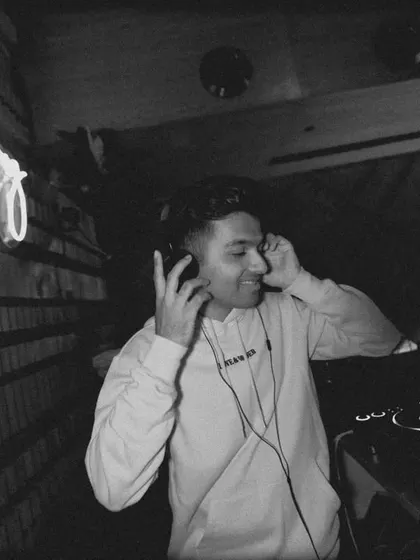 A black and white shot from my debut in Chennai, capturing a more focused, intimate moment as I cue up the next track.