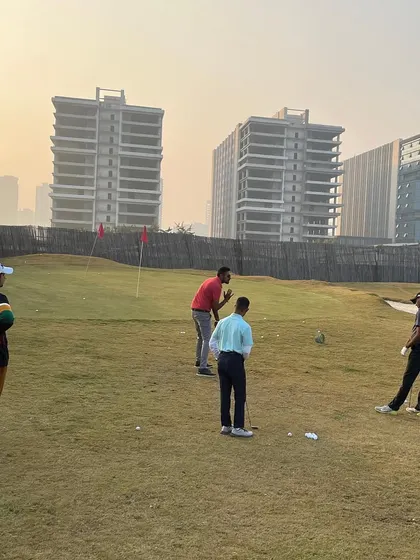 Players practicing their short game on our dedicated chipping and putting green. This area is crucial for improving your score on the course.