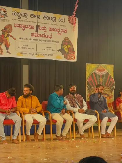Sharing a laugh with fellow dignitaries on stage at a cultural event.