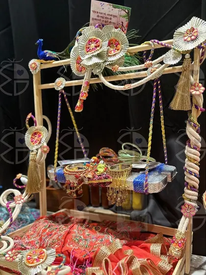 Another one of my Teej hamper designs. This one features a beautiful red 'saree' and bangles, arranged in a rustic wooden tray decorated with handcrafted flowers.