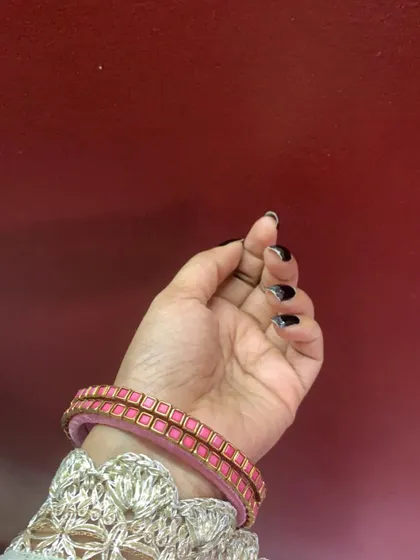 A beautiful pair of pink silk thread bangles with square kundan stone work. This is a classic design that can be customized in any colour.