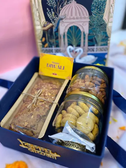 'The Joy Box' for Diwali, containing a wholewheat jaggery tea cake, almond jar, chilli cheese cookie jar, and a complimentary diya.