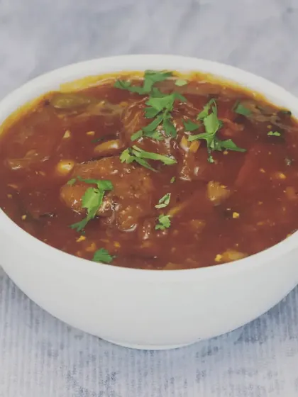This is my Veg Manchurian, featuring soft vegetable balls in a thick, tangy, and slightly spicy gravy. It's a perfect accompaniment to fried rice or noodles and is garnished with fresh coriander.