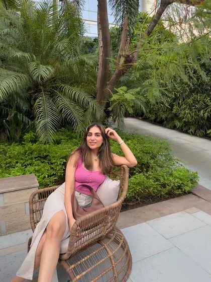 A happy, seated pose in the same outfit.