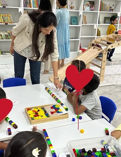 Guiding children through a hands-on activity at a workshop. My role is to facilitate discovery and encourage them to explore concepts for themselves.