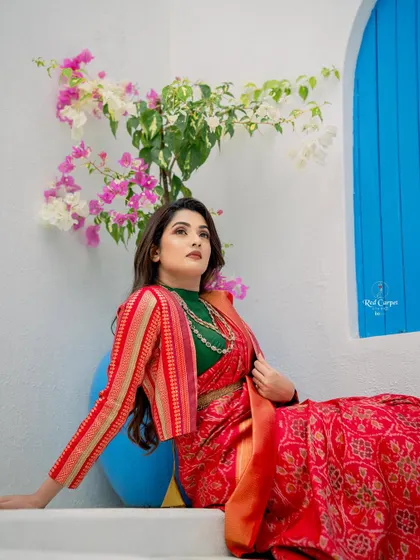 For a modern twist, I styled Sonal's saree with a striped red and gold jacket, creating a unique layered look.
