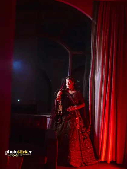 A full-length bridal portrait taken in a dimly lit room, using creative lighting to create a moody and artistic effect.