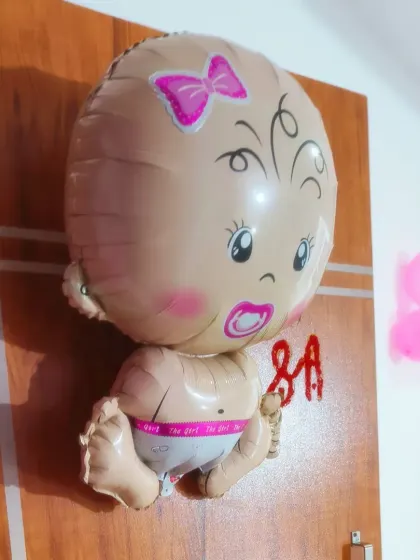Even a simple decoration can make a big impact. This basic balloon setup with a "Baby Girl" foil balloon is perfect for a small, intimate welcome home celebration with close family and friends.
