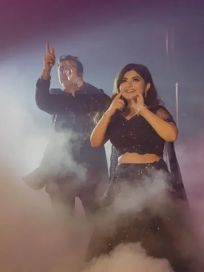 The couple makes a grand entrance on the dance floor through a cloud of smoke.