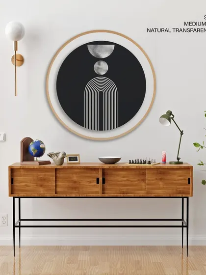 A striking mid-century modern abstract print in a large circular frame. The black and white geometric design with silver accents creates a bold and sophisticated statement piece.