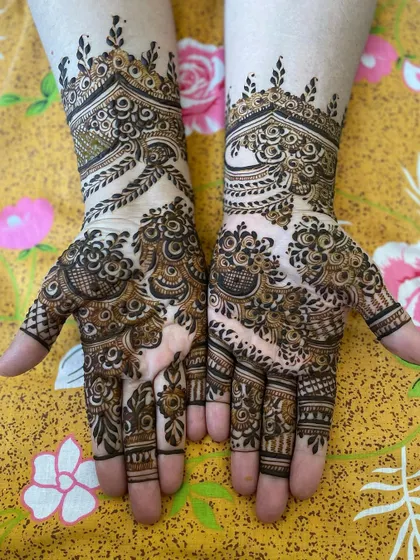 This design combines a leafy cuff with a palm full of varied patterns. It's a great example of a non-symmetrical but balanced look.