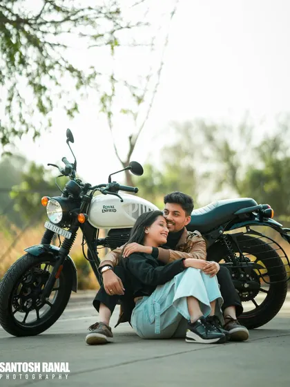 A stylish shot of a couple with a Royal Enfield, blending romance with a cool, modern aesthetic.