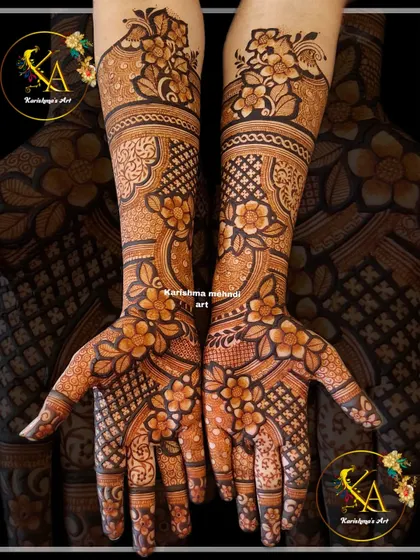 This intricate floral design covers the hands and arms in a dense pattern of flowers and leaves. The combination of bold florals and fine-line details creates a rich and luxurious effect.