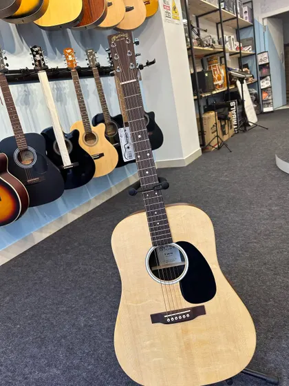 A Martin X Series acoustic guitar on display in our store. These guitars offer classic Martin tone and playability with durable, modern materials, making them perfect for any setting.