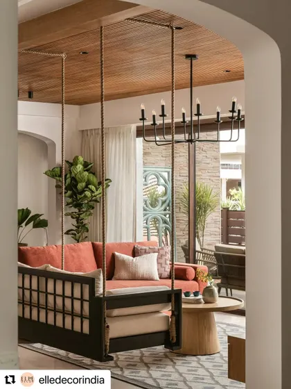 The informal living room's swing, as seen in Elle Decor. This home was envisioned for a well-travelled couple, and their journeys converge as memories brought together under one roof.