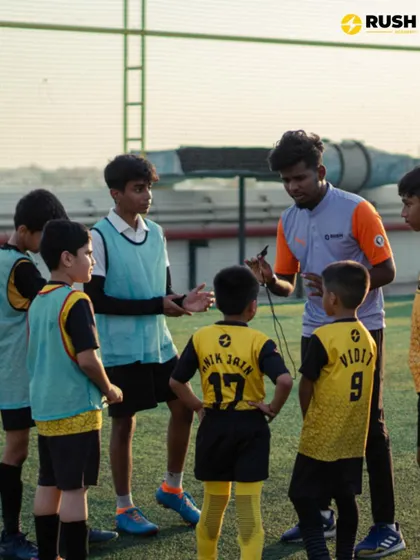 A coach gathers his team for a quick tactical discussion.