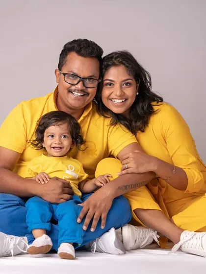 A vibrant family portrait with everyone dressed in cheerful yellow. Their coordinated outfits and bright smiles create a photo that is full of energy and happiness.
