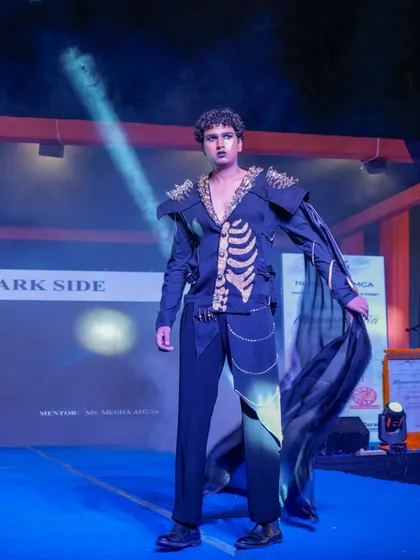A model on the runway in a costume inspired by the skeletal system, part of the 'Dark Side' theme.
