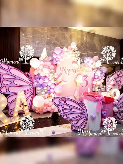 Another perspective of the beautiful butterfly stage, showing the depth and detail of the layered props and balloon decorations.