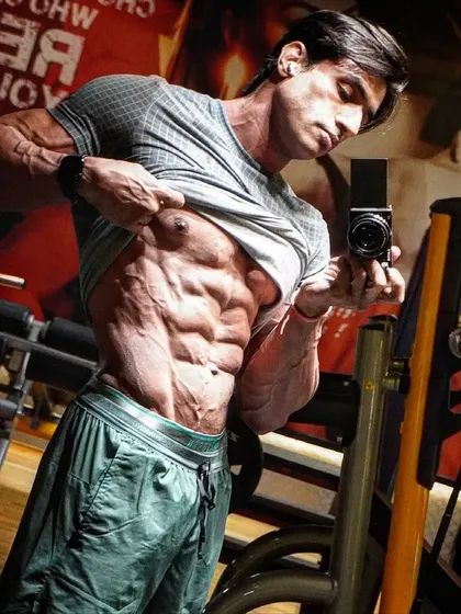 A selfie showing my shredded abs and obliques. Every chance taken in the gym leads to visible results.