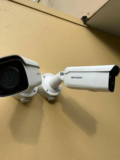A dual-camera setup using Hikvision models to cover two different angles from a single point. This is an efficient way to monitor both a walkway and an entrance simultaneously.