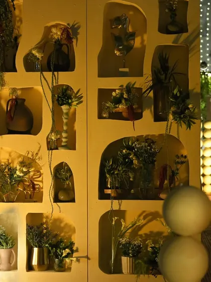 Another view of the custom niche wall, showing how it integrates with other decor elements like the spherical installation. The warm lighting creates a soft, inviting glow.