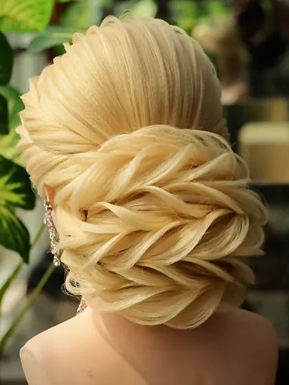 A beautiful reception bun hairstyle that is perfect for any grand occasion. The detailed texture and voluminous shape make it a true showstopper.