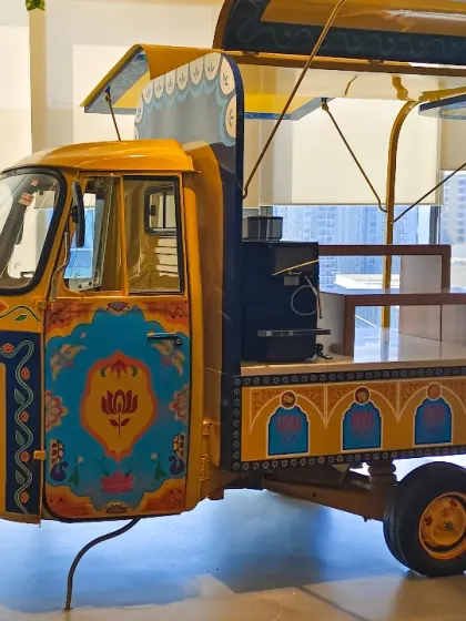 A side view of the completed auto-rickshaw installation. We designed it to be more than just a sculpture; it's a functional food counter, proving that art can be both beautiful and practical in a commercial space.