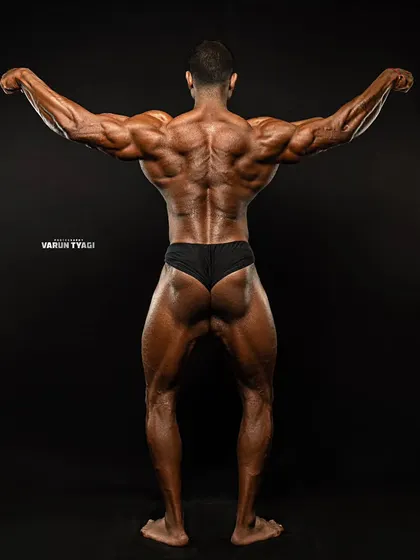 Shows are won from the back. This shot showcases the level of conditioning and muscular density required to compete at the highest level. My coaching focuses on developing a complete, 360-degree physique.