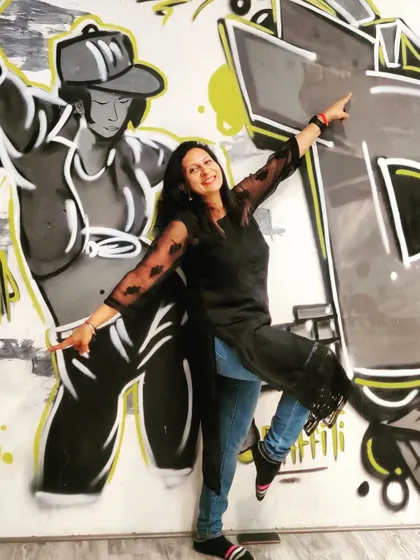 Passion makes dancers great. A fun shot against a graffiti wall that perfectly captures the hip-hop vibe.
