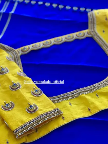 A bright yellow blouse with a 'chandbali' embroidered back and sleeves.