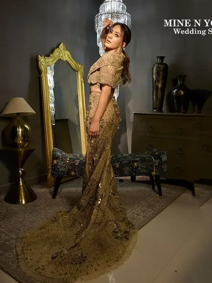 A high-fashion moment from the Mine N Yours Wedding Show. We created a dramatic and glamorous look with a sleek updo and striking makeup to match the golden, floor-length gown.