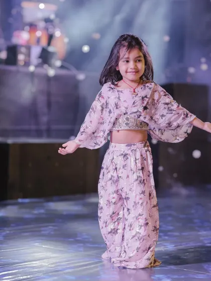 A duplicate of a featured image, this little star is lighting up the stage. We choreograph routines that are perfect for kids, ensuring they have a wonderful time performing for family and friends.