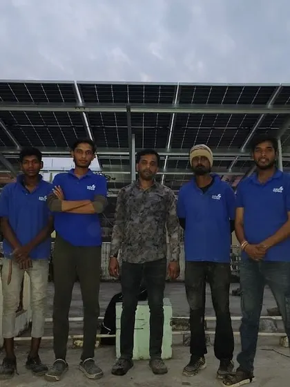 Our professional crew poses with a customer after completing another successful rooftop solar installation.